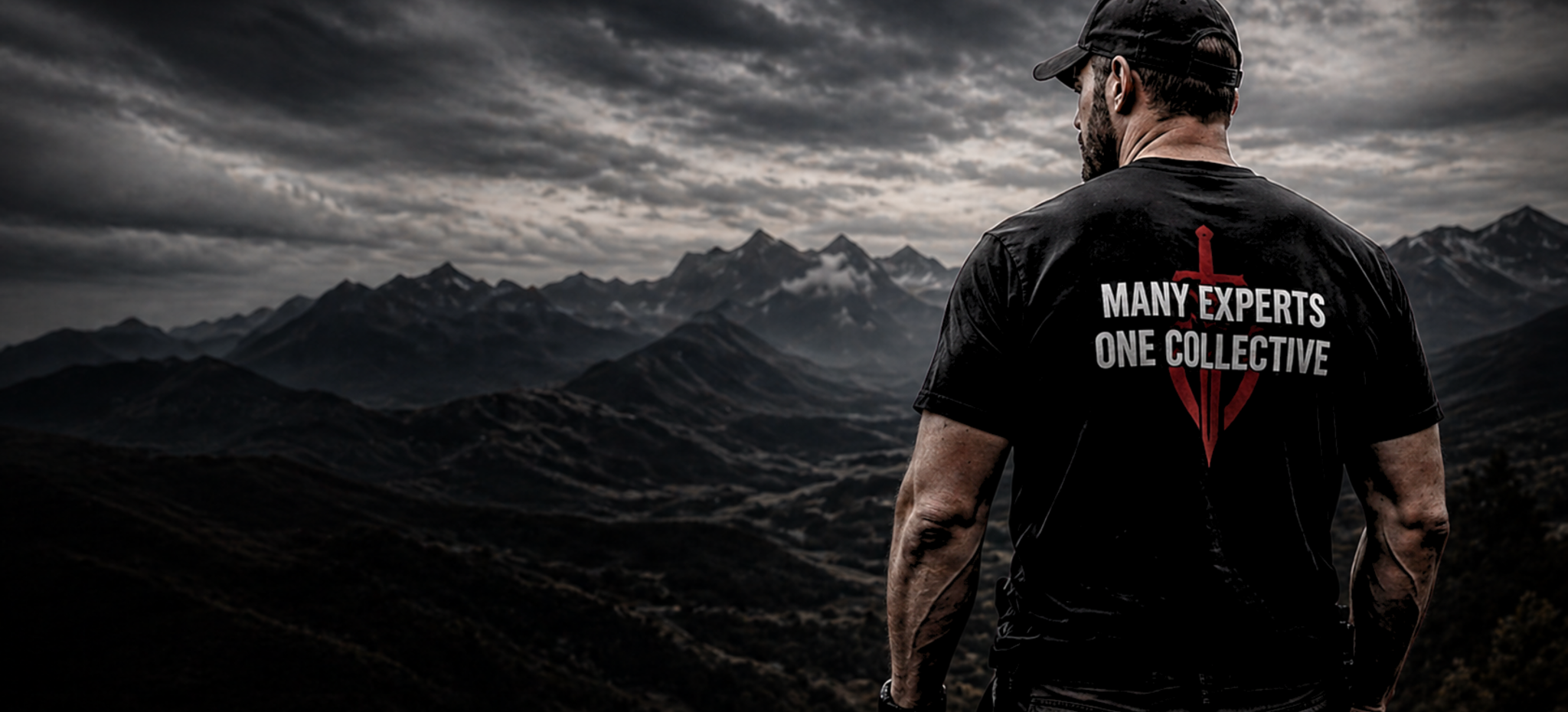 Man wearing a black t-shirt with 'Many Experts One Collective' logo against a mountainous landscape.